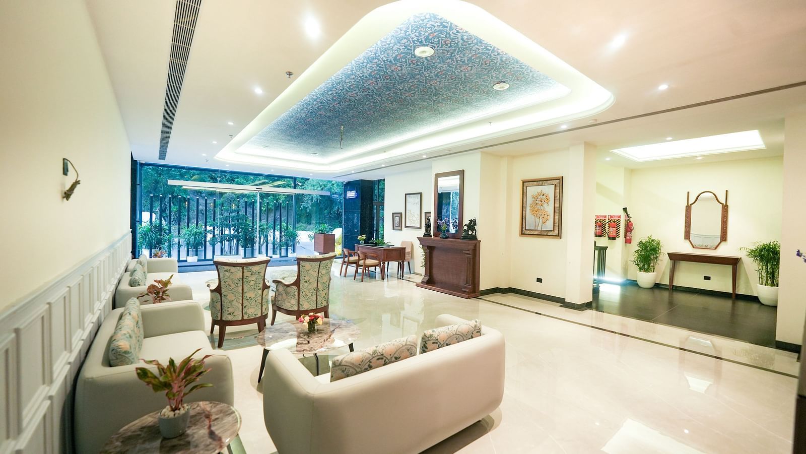 An image of a hotel lobby with cosy sofas, upholstered chairs, and a reception desk - NAMAMI BY ZENQ BANKHANDI