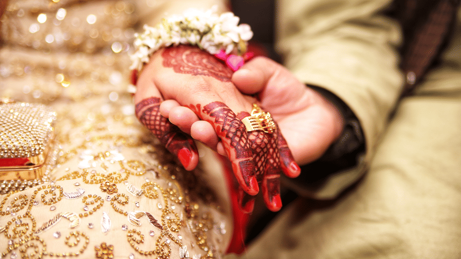 a husband and wife holding hands during a marriage ceremony