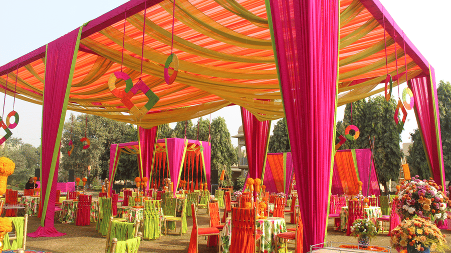 a canopy decorated with silk sheets and seats inside the canopy kept for festivities - heritage village resorts & spa, Manesar