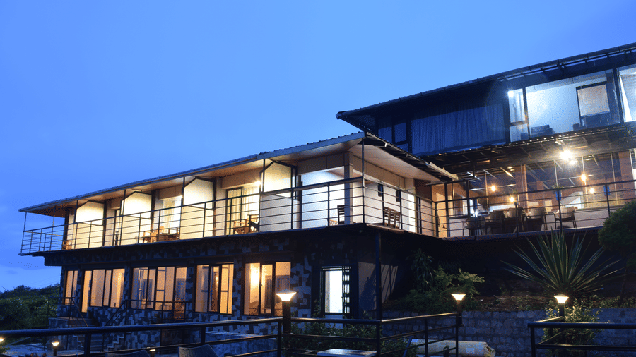 A night shot of the facade of the resort with blue sky in the background | Ibex Stays and Trails