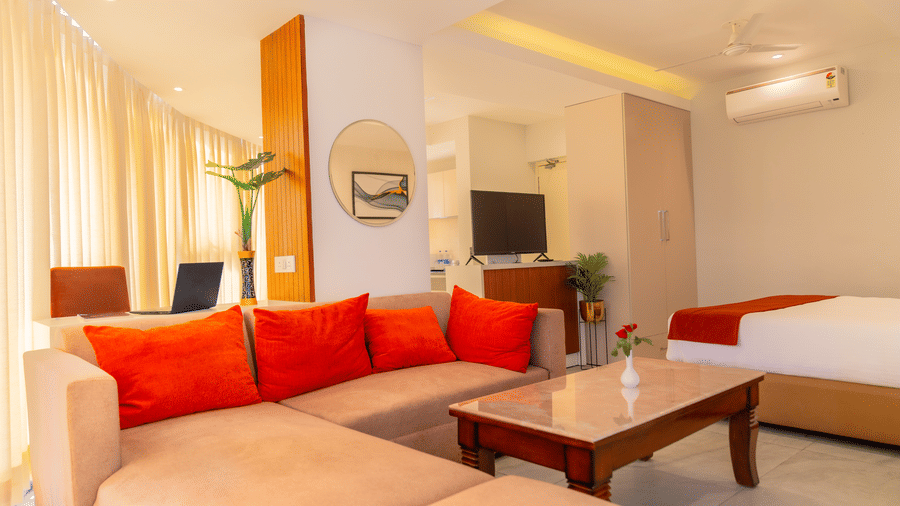 Living area with comfortable sofa of a Standard Room at Montclair Ananta, Elite.