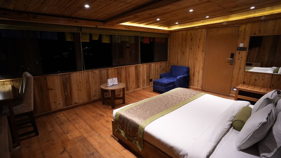 Comfortable wooden room with a queen-size bed and mountain view