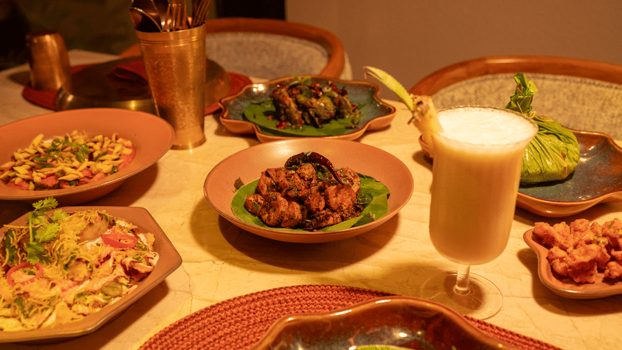 Assorted dishes and beverages served on a dining table at Jamun restaurant - Symphony Resorts