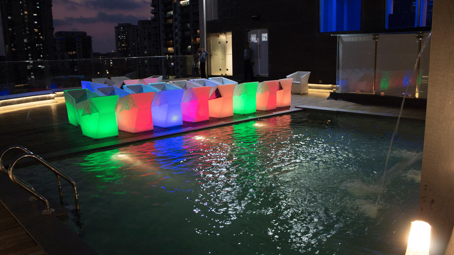 The Empresa Boutique Hotel - the rooftop area with colourful seats beside the swimming pool