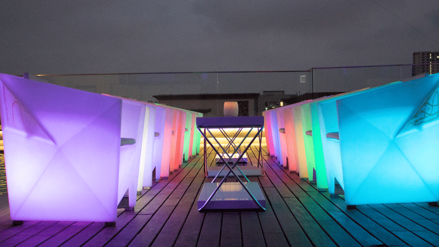 The Empresa Boutique Hotel - the rooftop area with colourful seats during nighttime
