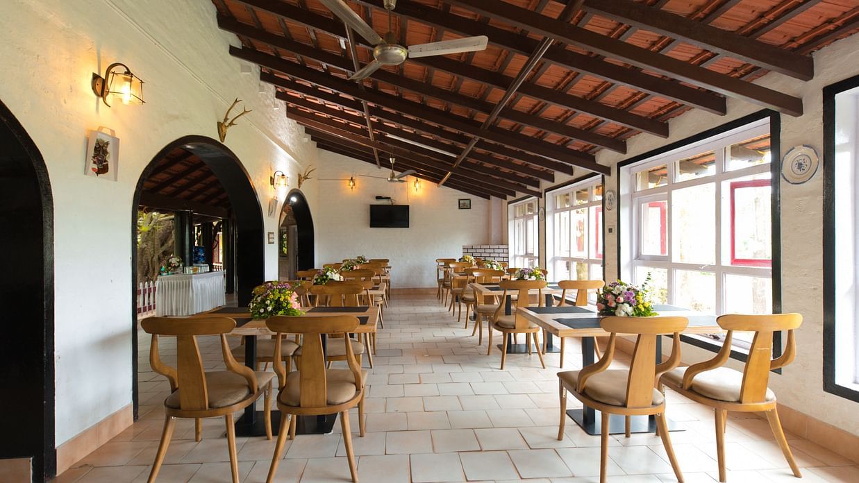 Seating arrangements inside the restaurant at The canopy, Capitol Village Resort, Madikeri