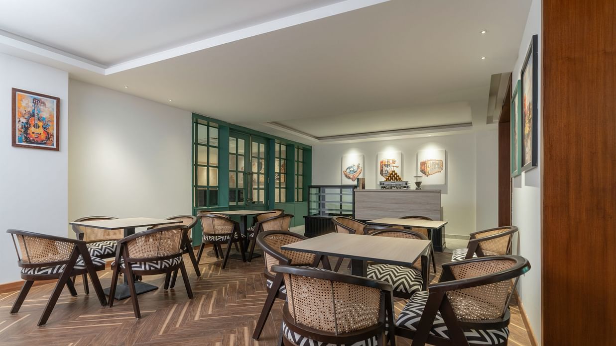 Cozy cafe seating area with comfortable chairs and tables.