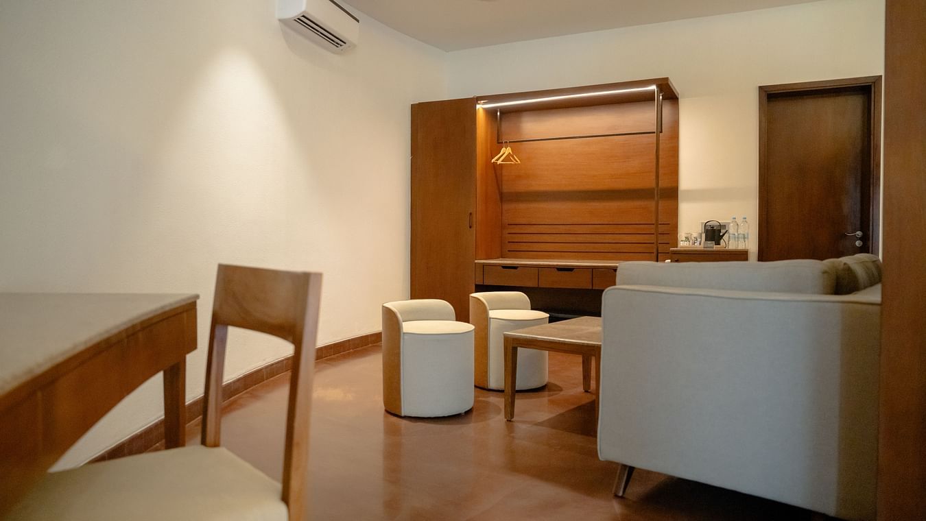 Cosy lounge space with wooden flooring, cushioned seating, and minimalist decor at Ananta Spa and Resort, Ajabgarh.