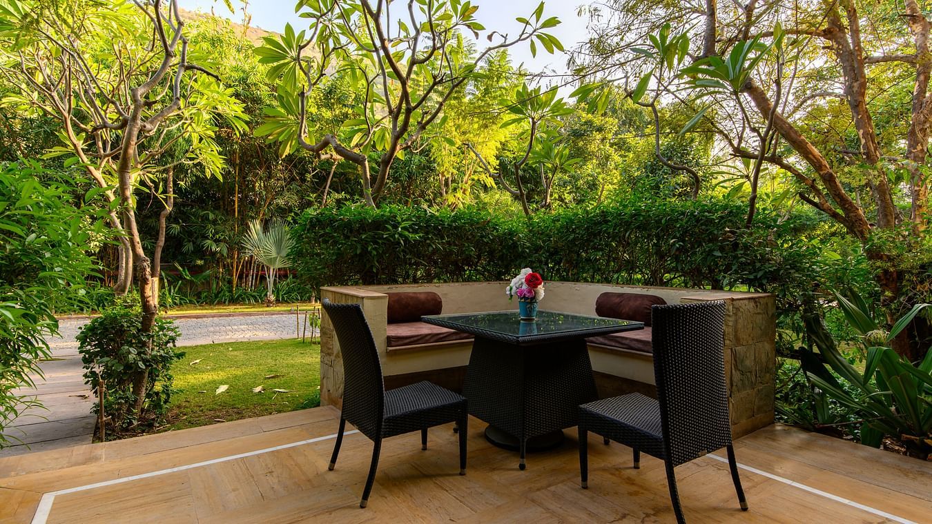 outdoor seating surrounded by lush greenery