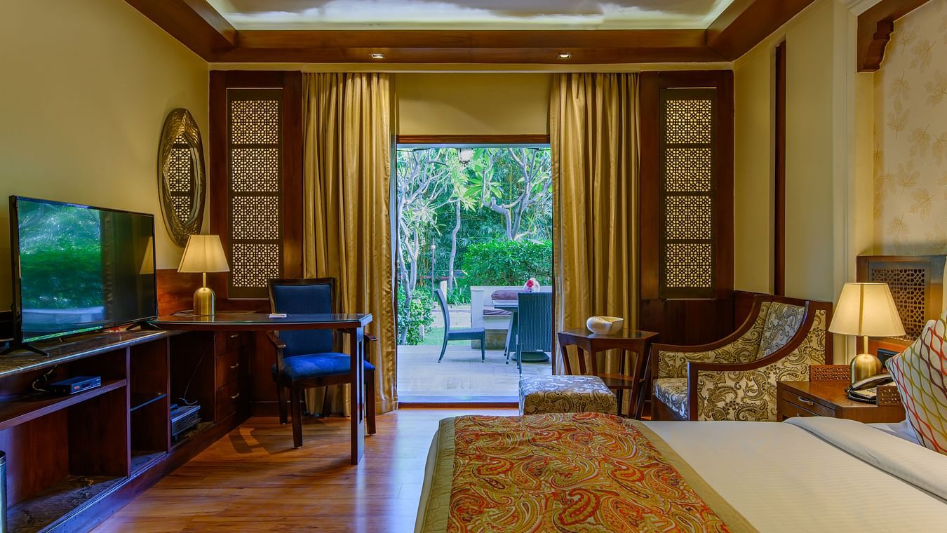 view of television, chairs and other amenities in one of the rooms at Ananta Pushkar