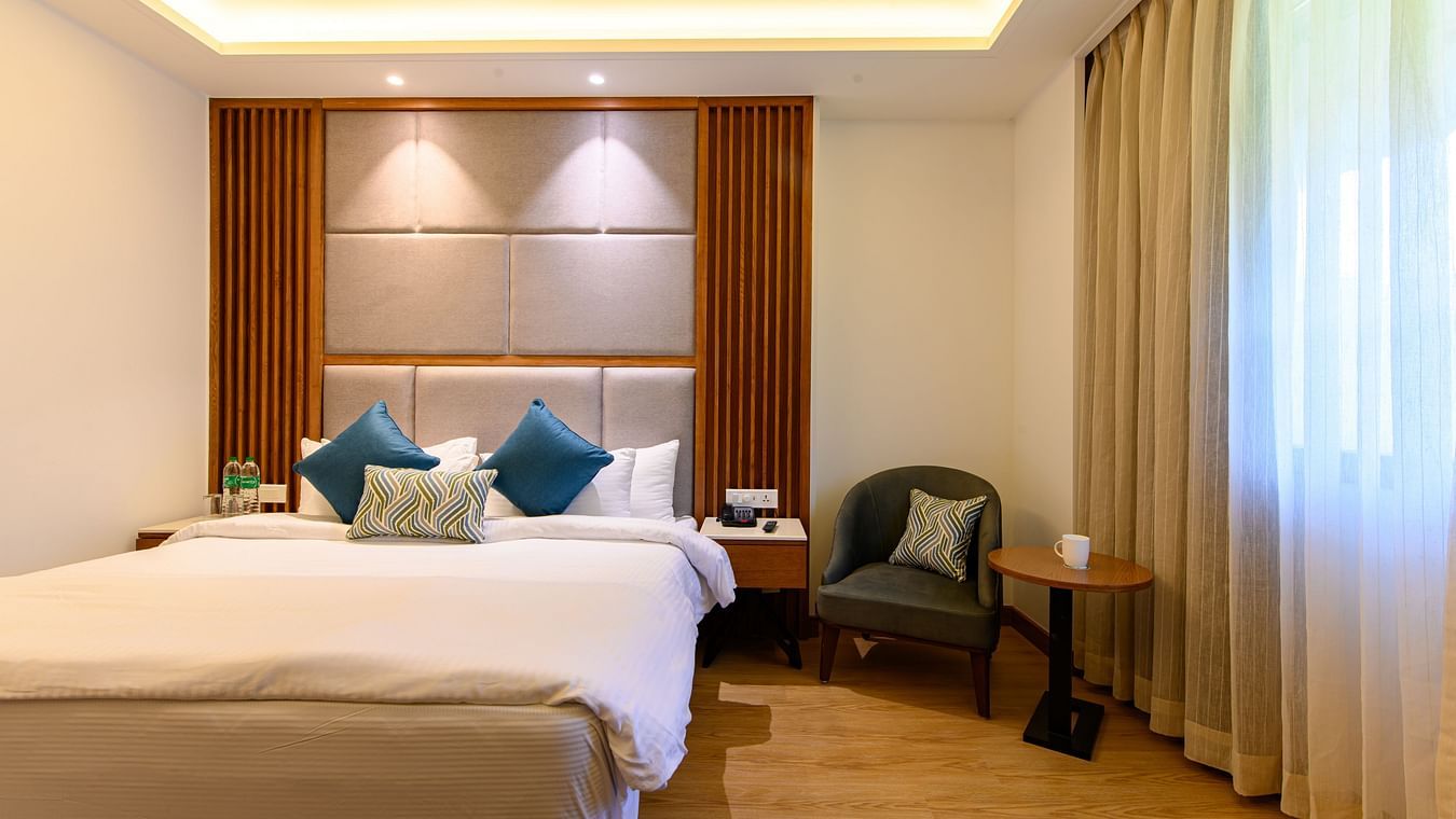 The interiors of the Classic Rooms in Pushkar featuring a bed, a sofa chair and exquisite furnishings at our resort 13