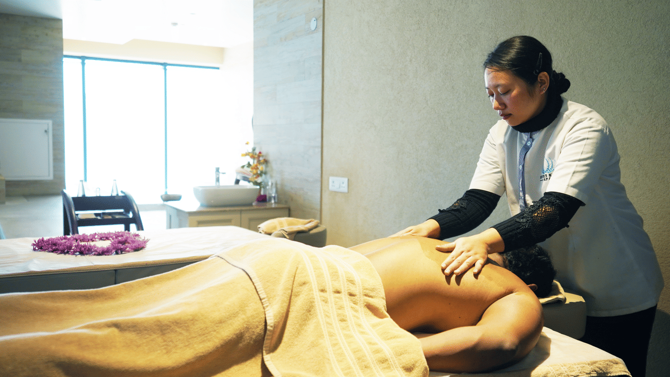 A person receiving a massage, highlighting the spa's focus on relaxation and wellness - Karma Lakelands.