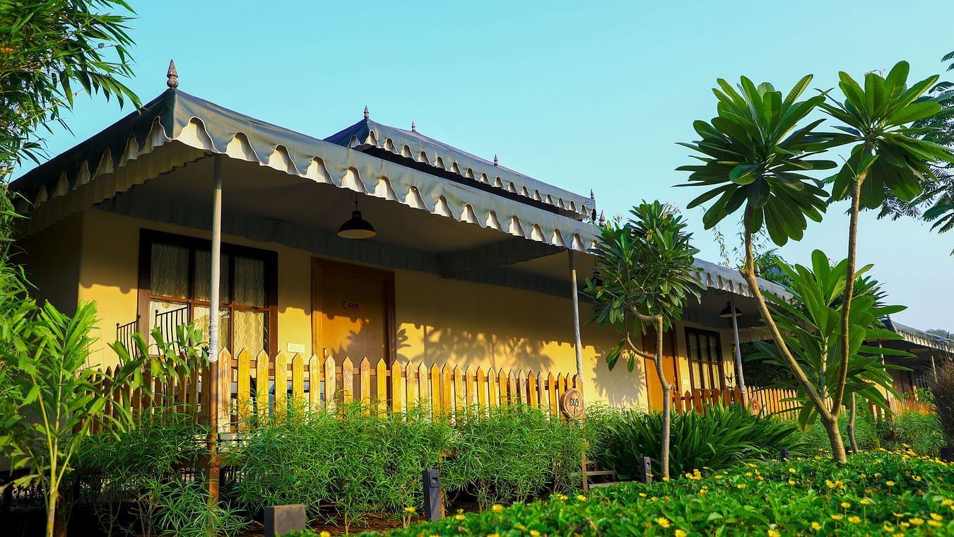 The exterior of a villa surrounded by greenery