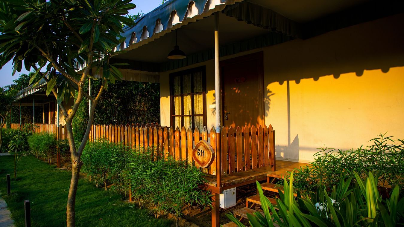 Villa exterior with a border of bushes surrounding the building