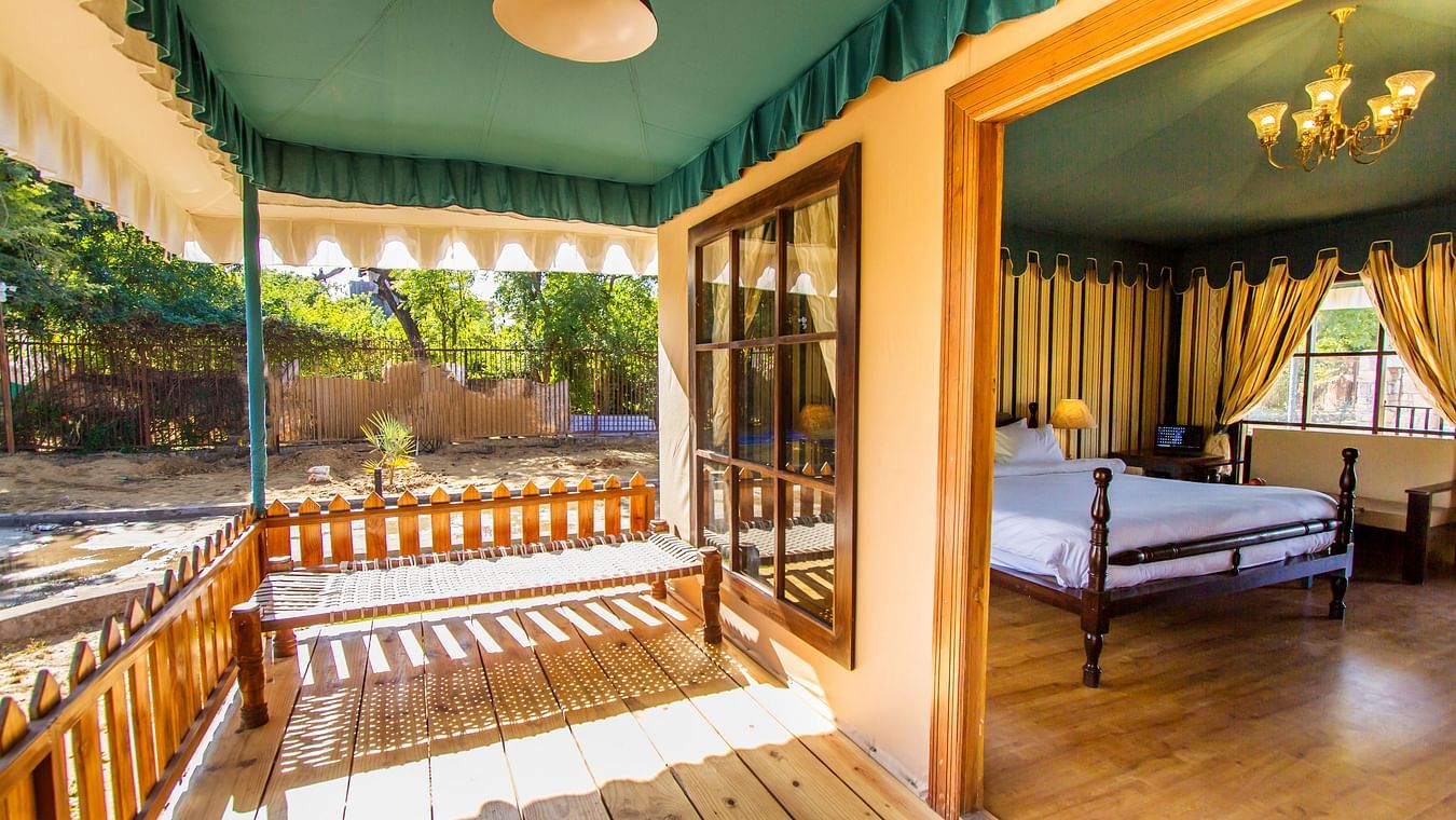 the outside veranda of the luxury tents in Ranthamborea king size bed of one of the tents in Ranthambore at The Baagh Ananta Elite