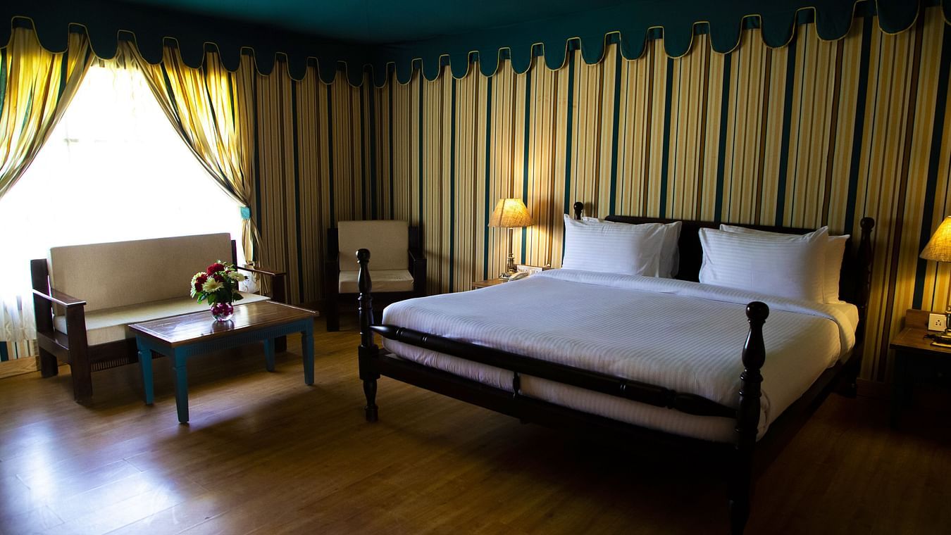 A spacious bedroom with a large bed and a sofa