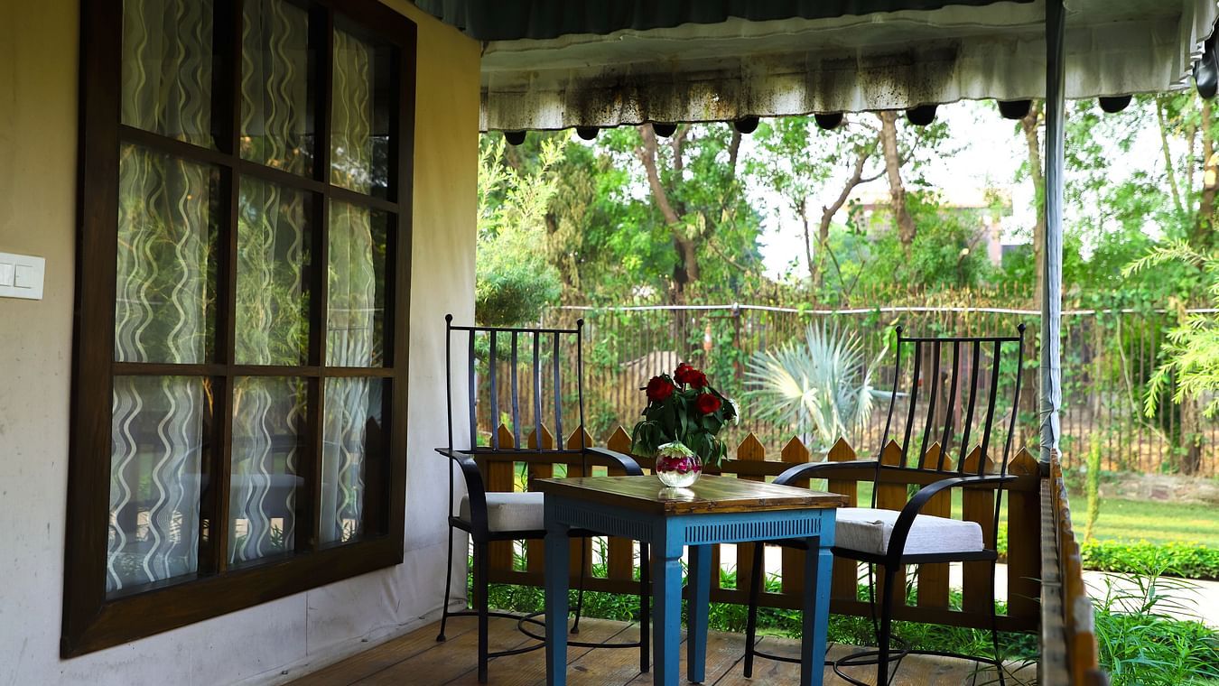 A table-chair set sits on the veranda