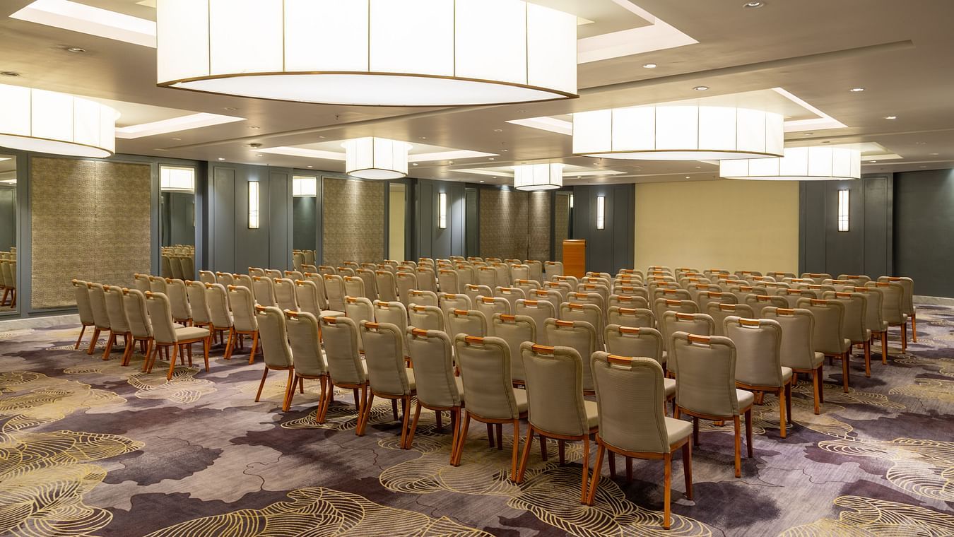 Spacious banquet hall with interior lighting and neatly arranged chair seating at The Residency Towers Puducherry
