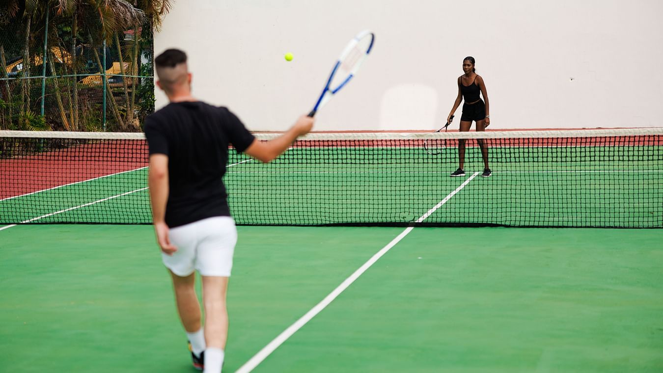 people playing tennis at the court - The Soco House