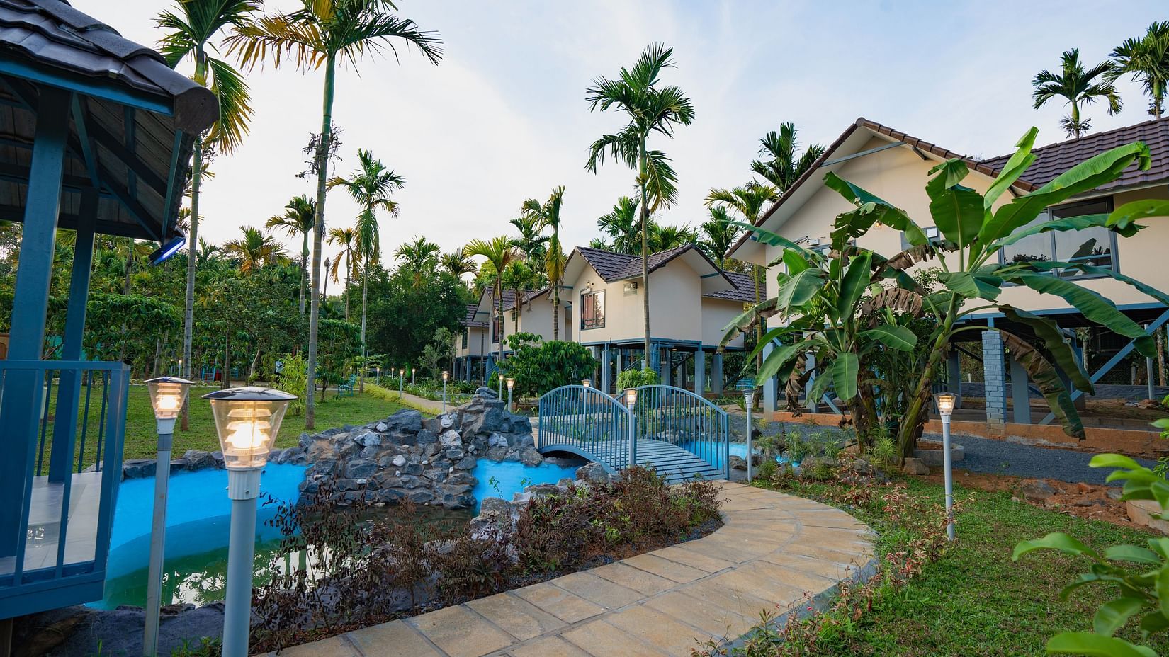 Pathway leading to a building with plants surrounding it at Feel Free Retreat, Wayanad