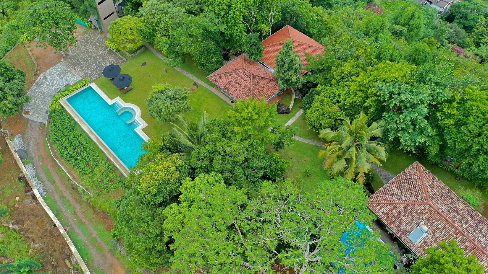  A picturesque aerial shot of a villa surrounded by greenery, featuring a private swimming pool and spacious grounds - Heavensa Villas and Suites by the Clarks, Galle