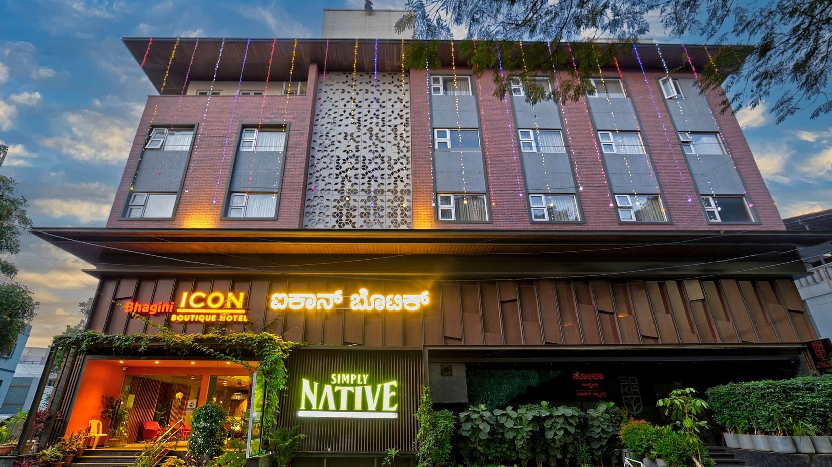 A modern and stylish hotel building with a rustic facade, featuring the name ICON Boutique Hotel by Bhagini and NATIVE in bold letters.
