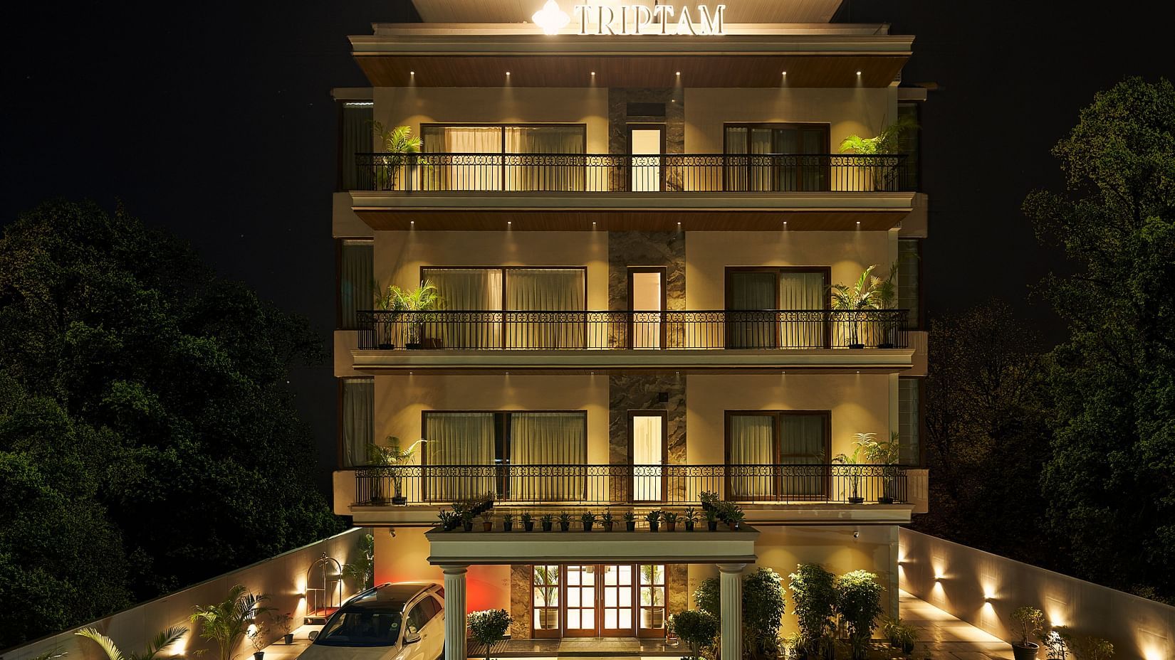 exterior facade of Triptam Hotel, Vrindavan lit up at night