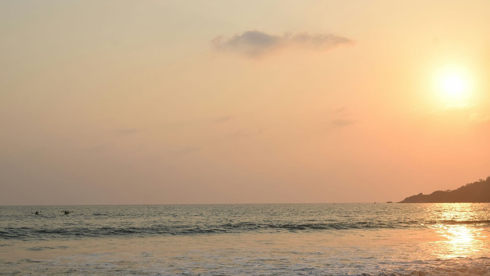 An overview of Patnem Beach with the sun setting in the background.