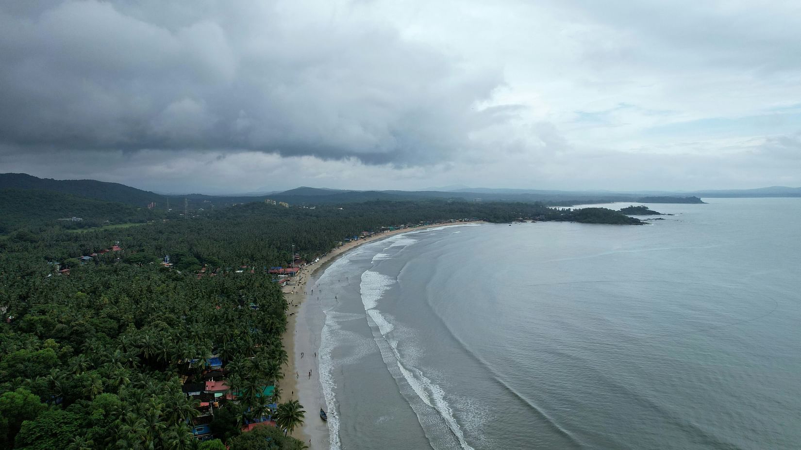 An aerial view of Palelom Beach with the tropic forest and shore in view.
