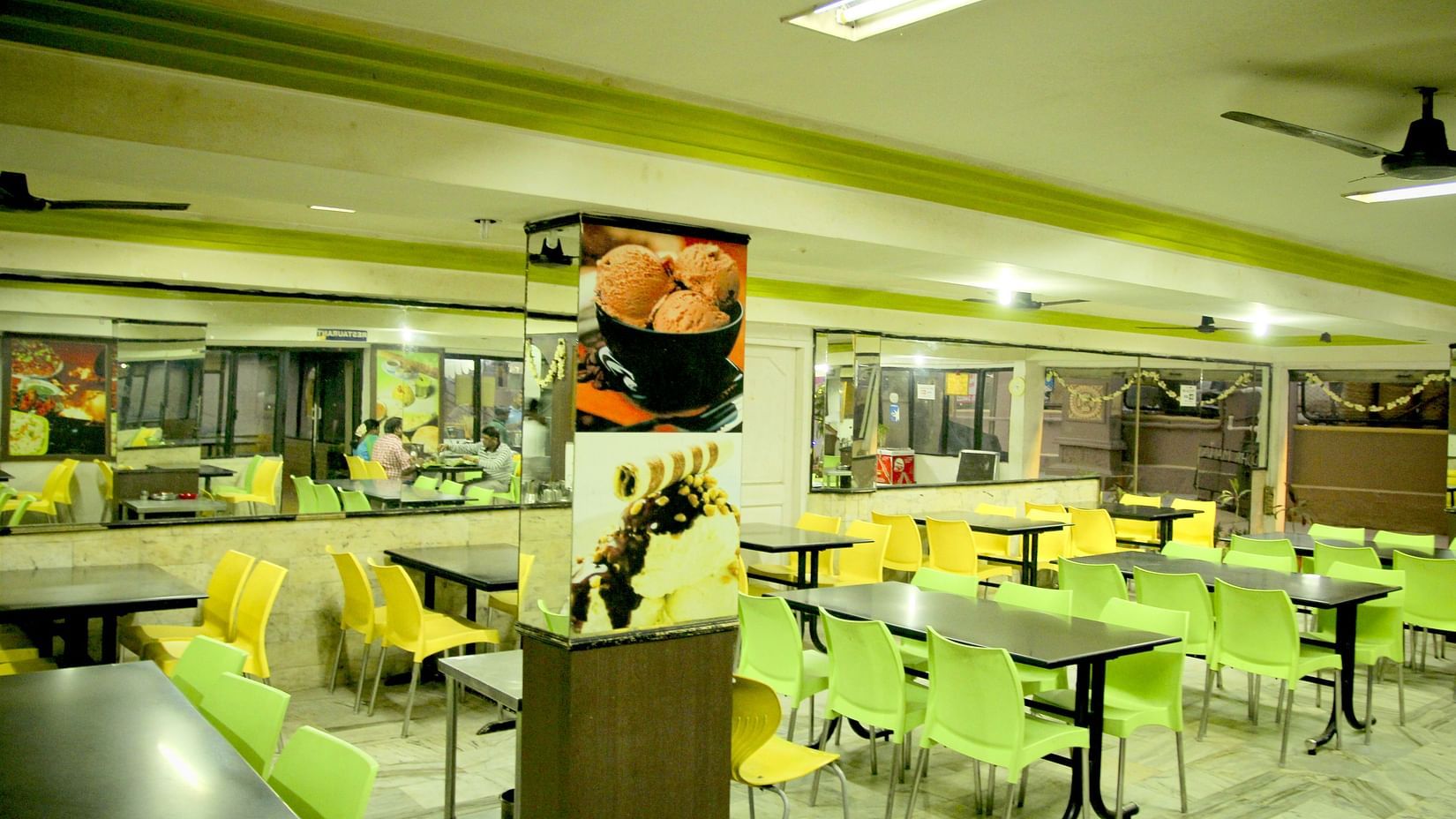  Hotel Yasodha Towers - Interior view of the restaurant featuring numerous seating options