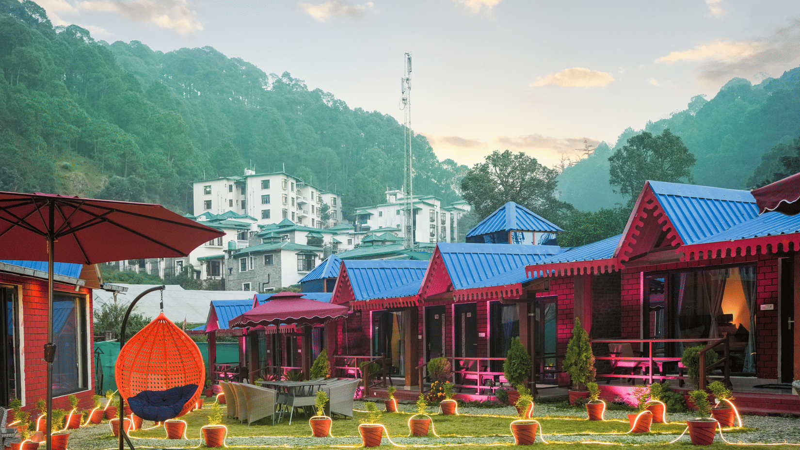 The exterior of Sol Glow Resort, Nainital on a valley with a view of the hills behind.