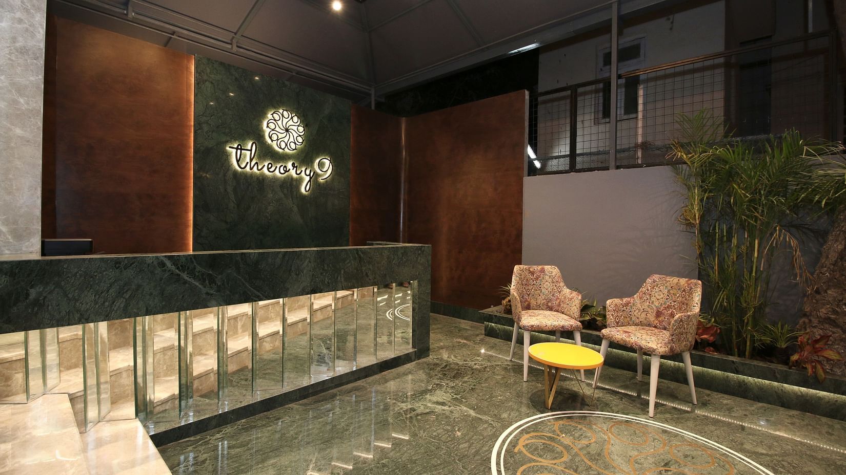 exterior facade with two chairs and a small table - theory9 bandra