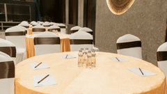 Conference table setup at Biznotel by Pride Surat arranged with notepads, pens, and water bottles.