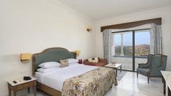 Fateh Vilas Udaipur - Interior view of the Punge Pool Suite featuring a queen size bed white decor and a plunge pool