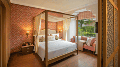 luxurious room with a commodious king size bed and cushy sofa designed with plush interiors