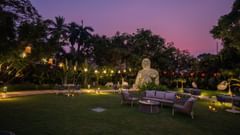 A lush garden with seating arrangements at Heritage Village Resorts & Spa.