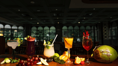 A variety of colourful cocktails arranged on a table at Hotel Polo Towers, including a mojito, a piña colada, and a red wine.