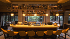 A well-stocked bar at Hotel Polo Towers with a variety of spirits and cocktails, inviting guests to relax and unwind.