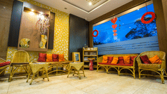 Seating arrangements with a floor to ceiling glass at Burma Banquet Hall - Hotel Shompen