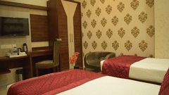 A modern twin bedroom with stylish interiors at Hotel Uday Palace, offering comfortable hotel accommodation in Varanasi.