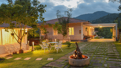 campfire in front of a room next to a garden at Ibex Resort, Kotagiri