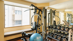 The image of the gym with the gym equipment and a window with view at Marasa Sarovar Portico, Rajkot