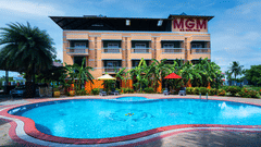 Image featuring the facade of MGM Vailankanni Residency and a large swimming pool in front of it