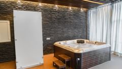 A jacuzzi placed in a room next to a wardrobe at Montclair Ananta, Elite.