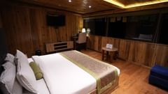 Cozy wooden room with a double bed and mountain view