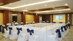 Conference room at Nemesia set up for a meeting with tables arranged in a U-shape.