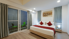 Side view of Studio King Room with bed and balcony access at Nest by Rivido Apart Hotel, Bannerghatta Road