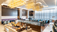 A buffet setup at Nirvana Sarovar Portico, Gorakhpur featuring a spread of food items, serving counters, and dining seating. 