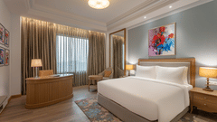 a double bed, side table, and work desk in one of the rooms at Park Plaza, Jalandhar