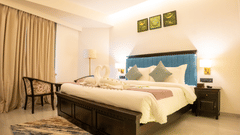 Image of a room with bed and and three frames above the bed at Pride Elite Daman.